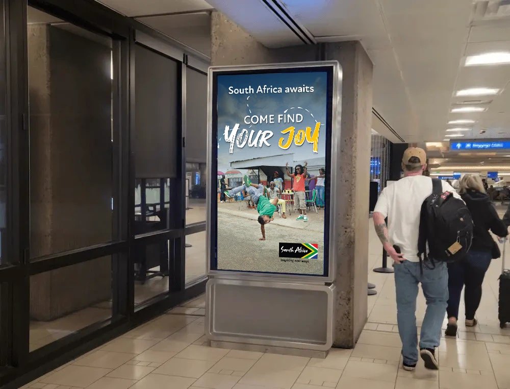 Come Find Your Joy digital poster in an airport